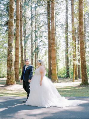 Bride With Wedding Dress Train and Groom in Tuxedo Walk in Forest