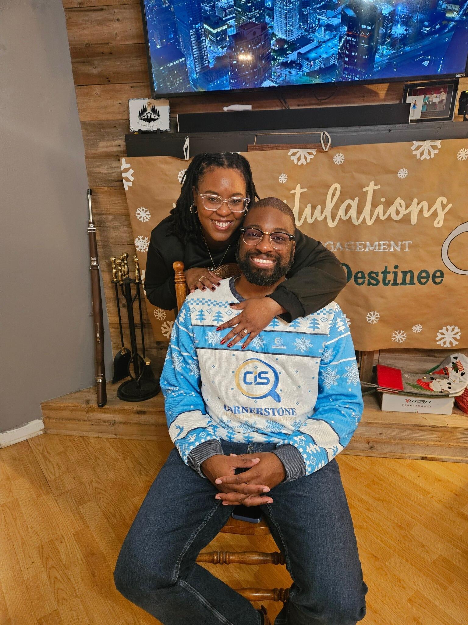 Brandon had a whole production in place to pull off the proposal. He told Destinee along with their friends that he was hosting an Ugly Sweater Christmas party. Once the day came and there was “not much seating,” his excuse to get Destinee out of the house was to go to Bayou Christian Church to grab chairs. With the help of Denise and Dawn, we were able to get her to the church. Once he got into the church, he originally proposed with a ring pop. That didn’t go over well then the real ring came. She said yes and now they are planning a wedding
