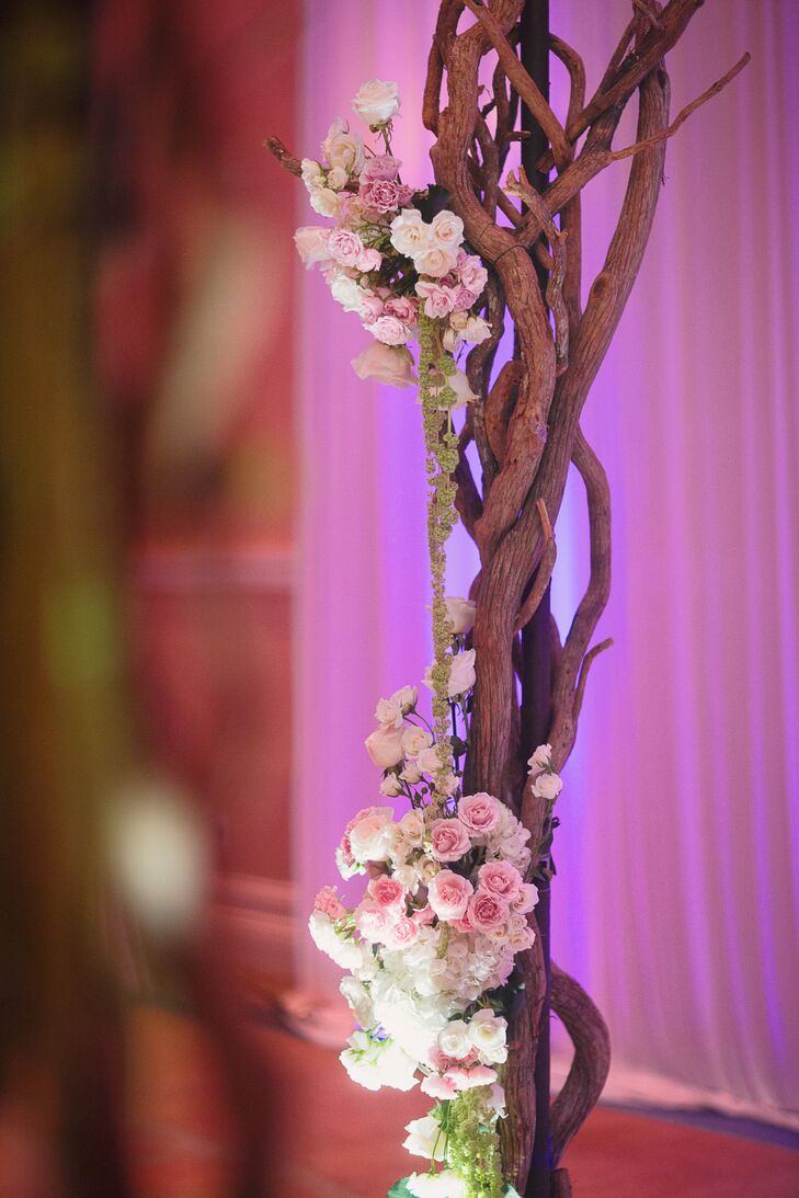 The chuppah was decorated with natural branches, ivy vines, pink roses, white hydrangea and crystals.