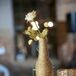 In addition to the lush ivory floral arrangements, the reception tables were also decorated with simple bunches of ivory spray roses placed in homemade twine-wrapped vases.