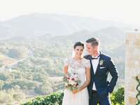 Bride and groom with California mountains behind them