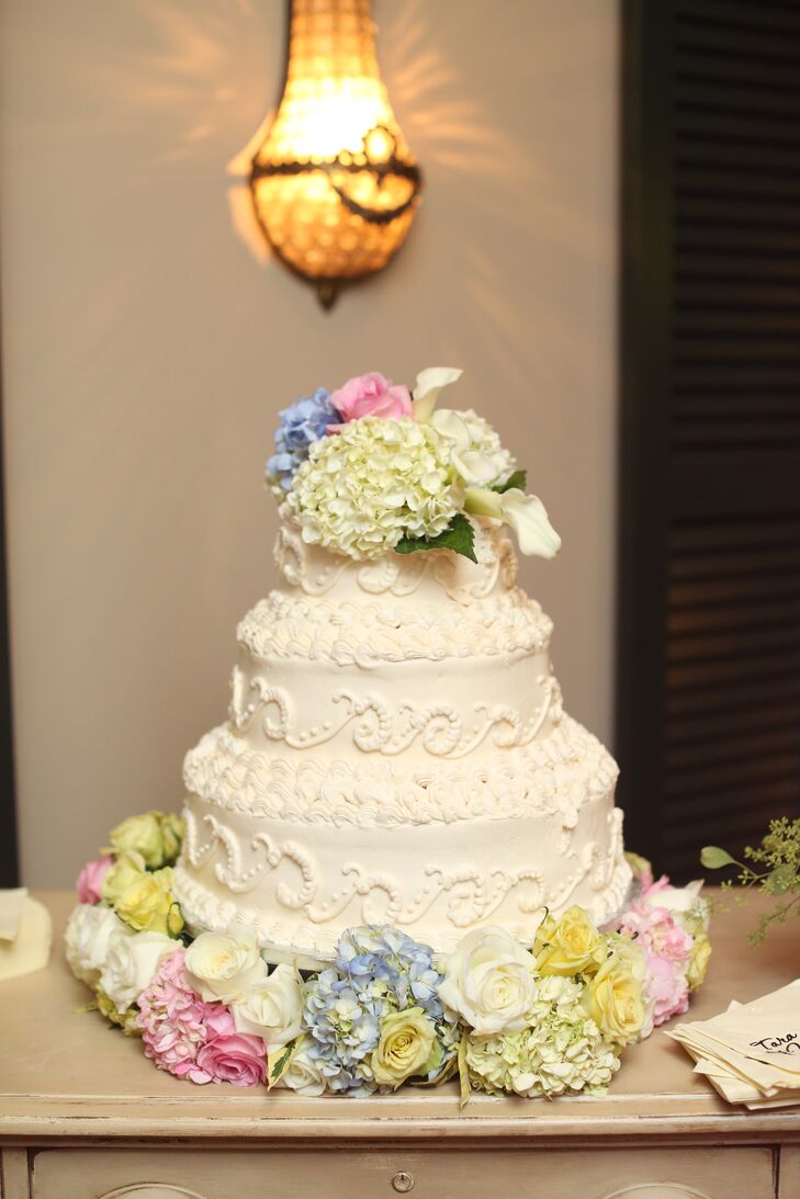 The romantic three-tiered buttercream was topped with pastel fresh flowers to add a soft feel.
