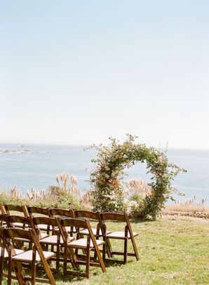 Waterfront Wedding Ceremony with Floral Arch at Timber Cove Resort in Jenner, California