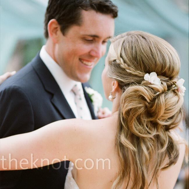 Andrew loves when Courtney’s hair is swept back in a side part, so for their wedding day she wore it just that way -- curled, half up, half down with a braid on the side. For a personal touch, she added flowers picked from her father and stepmother’s garden.