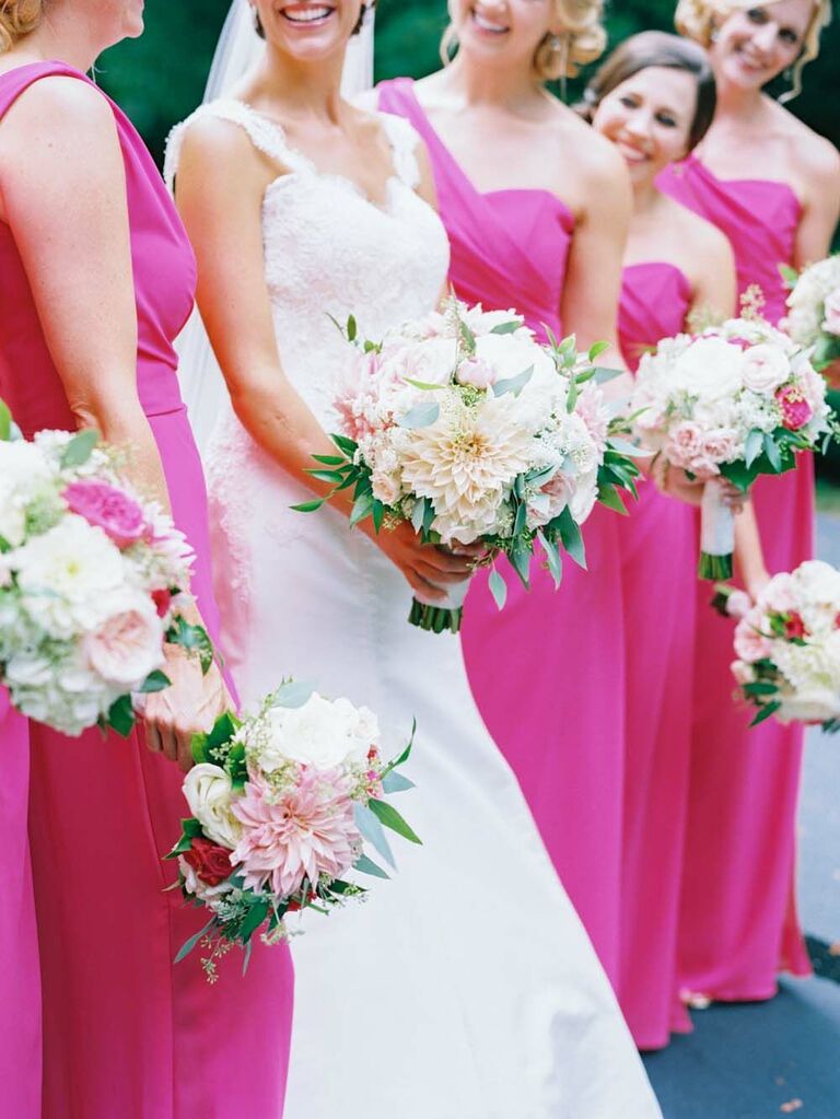 bridesmaids wearing viva magenta one-shoulder dresses