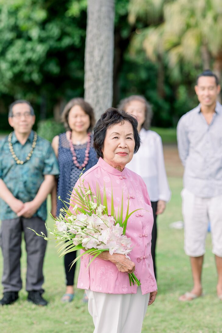 Bride in Traditional Pink Tang Suit and Orchid Bouquet at Hawaiian Vow Renewal