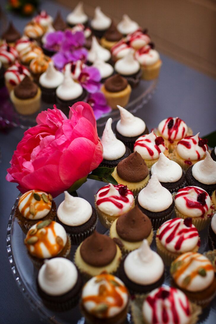 The bride and groom chose an less traditional cupcake tower instead of a cake for the same reason they served all of their meals in a family style fashion; they wanted their guests to roam around and mingle.