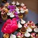 The bride and groom chose an less traditional cupcake tower instead of a cake for the same reason they served all of their meals in a family style fashion; they wanted their guests to roam around and mingle.