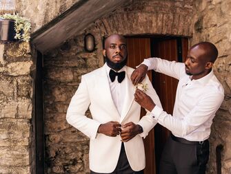 A groom and his best man prepare for the big day.