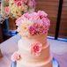 Three-Tier White Wedding Cake with Pink Flowers
