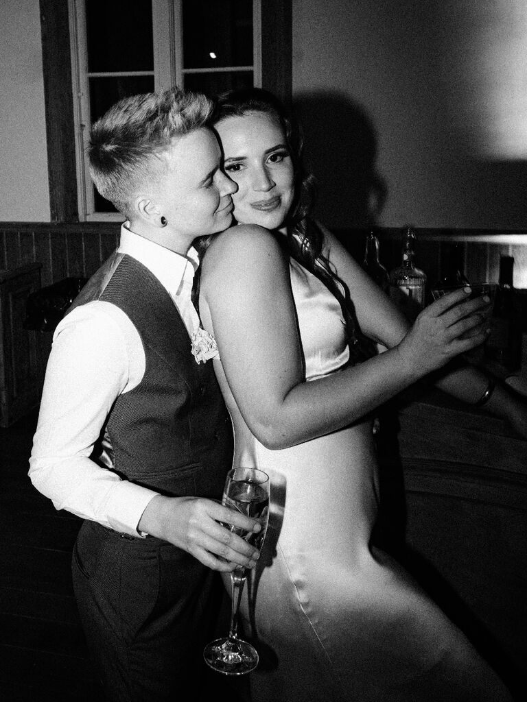 Couple posing for direct flash photos at wedding reception