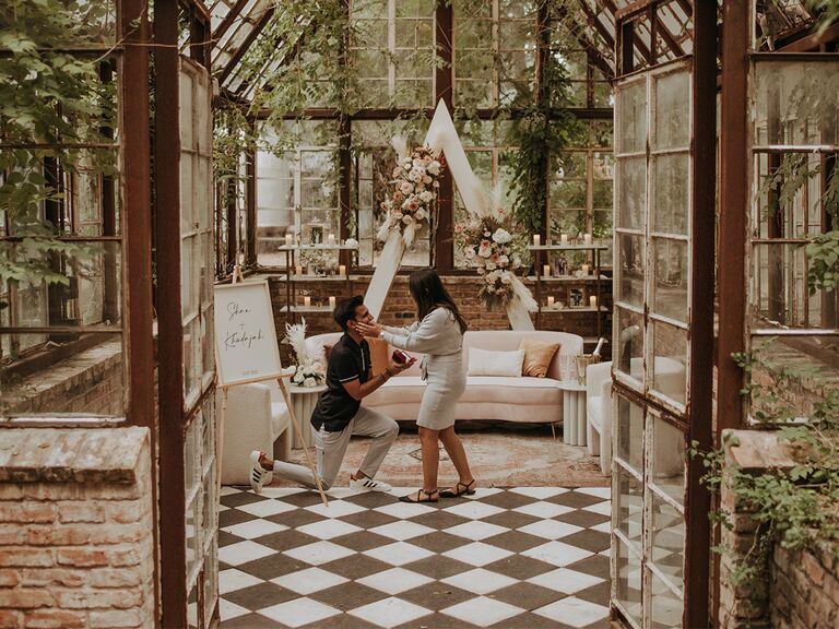 couple getting engaged in a beautiful indoor garden