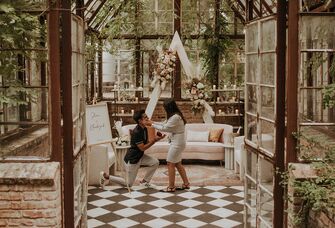 couple getting engaged in a beautiful indoor garden