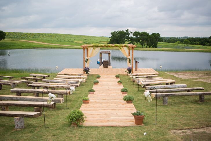 The couple had to build the ceremony site from scratch to provide seating for their guests. All of the lumber used in the ceremony benches was from cedar trees cut on site. The bride’s family worked together to build the benches, aisle and wedding arch.