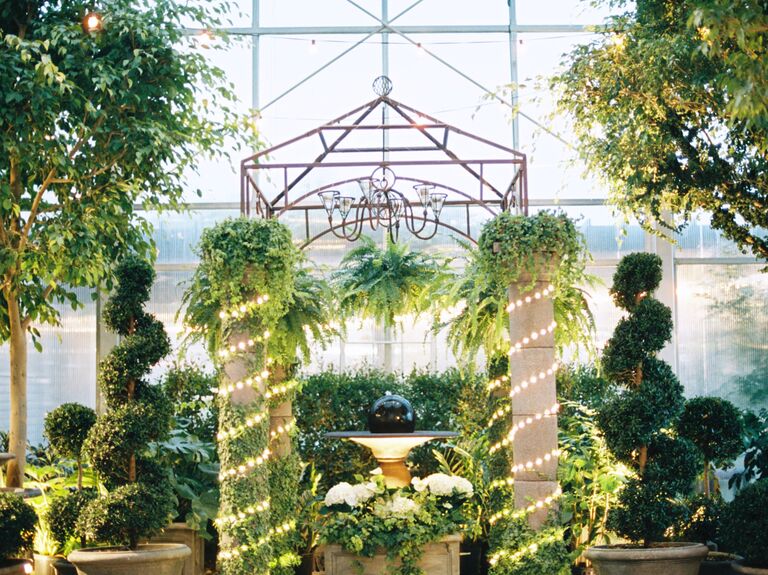 topiaries and stone columns at greenhouse wedding venue decorated with LED tube lights