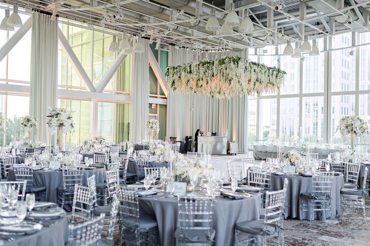 Lucite Chiavari Chairs with Blue Tablecloths Under Hanging Hydrangea Installation