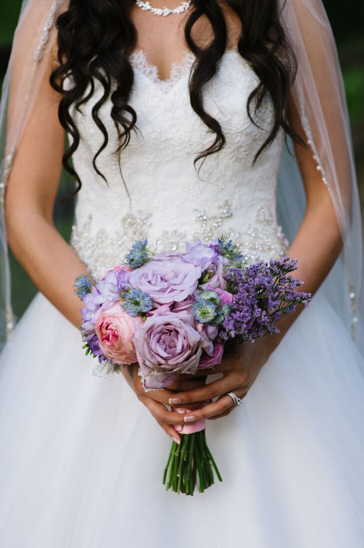 Jennifer carried a bouquet with purple roses, pink peonies and lavender on her wedding day.