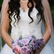 Jennifer carried a bouquet with purple roses, pink peonies and lavender on her wedding day.