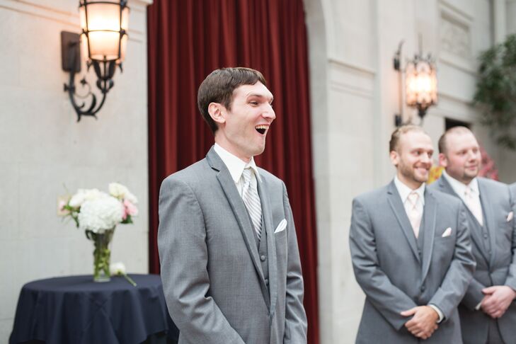 Justin stood at the front of the altar when Elon walked into the ceremony space, and his mouth dropped at the first look of his bride. Justin wore a light gray suit by American Commodore Tuxedo with an ivory silk tie that matched Elon's wedding dress. The groomsmen matched Justin, wearing the same-colored suit and tie.