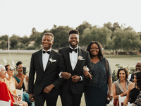 Groom and groom's parents walking down the aisle