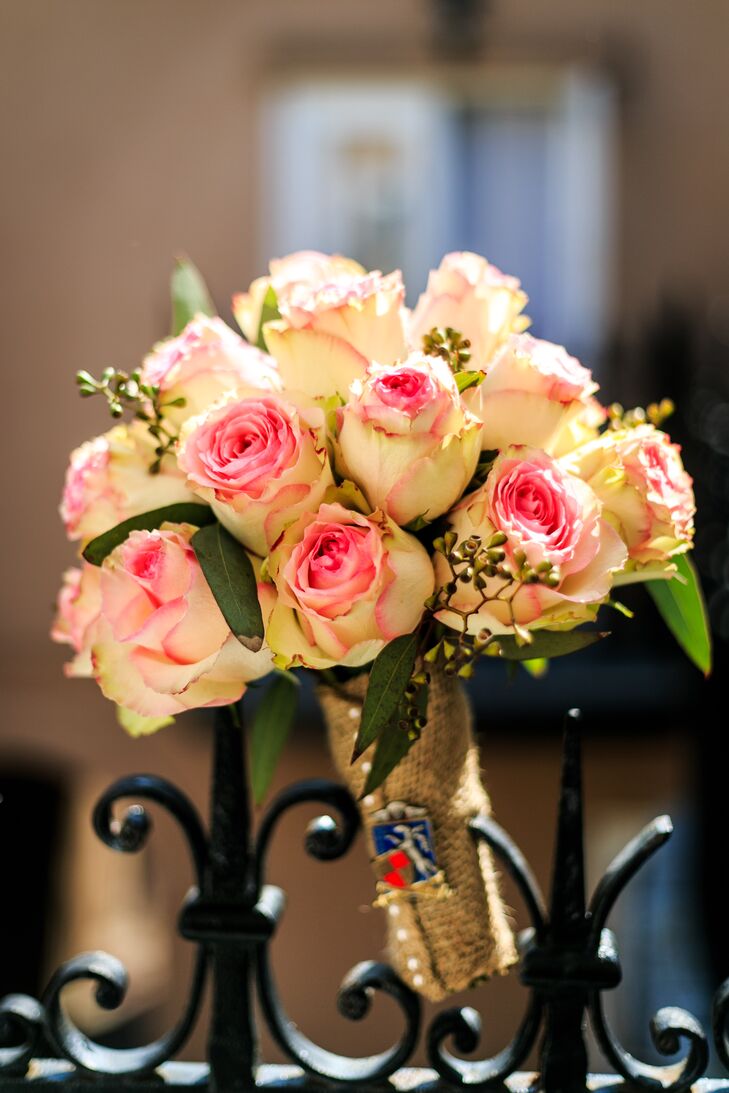 Amanda carried blush roses and seeded eucalyptus in her lush bouquet. The stems were wrapped in burlap for a rustic flair. Amanda and Ben loved how the bouquet complemented the neutral ivory, blush and blue color palette.