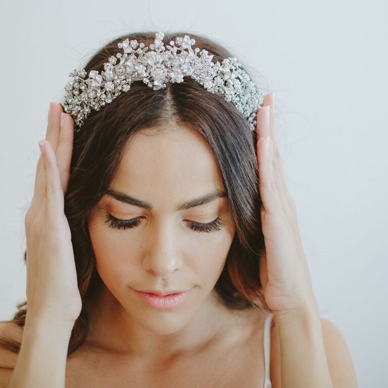 Model wears a beautiful tiara with sparkling jewels. 