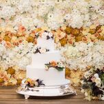 three-tier fall wedding cake decorated with hand-piped polka dots and fresh flowers