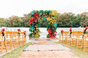 Colorful Flower Arch and Rug-Lined Ceremony Aisle at Waller Creek Boathouse in Austin, Texas