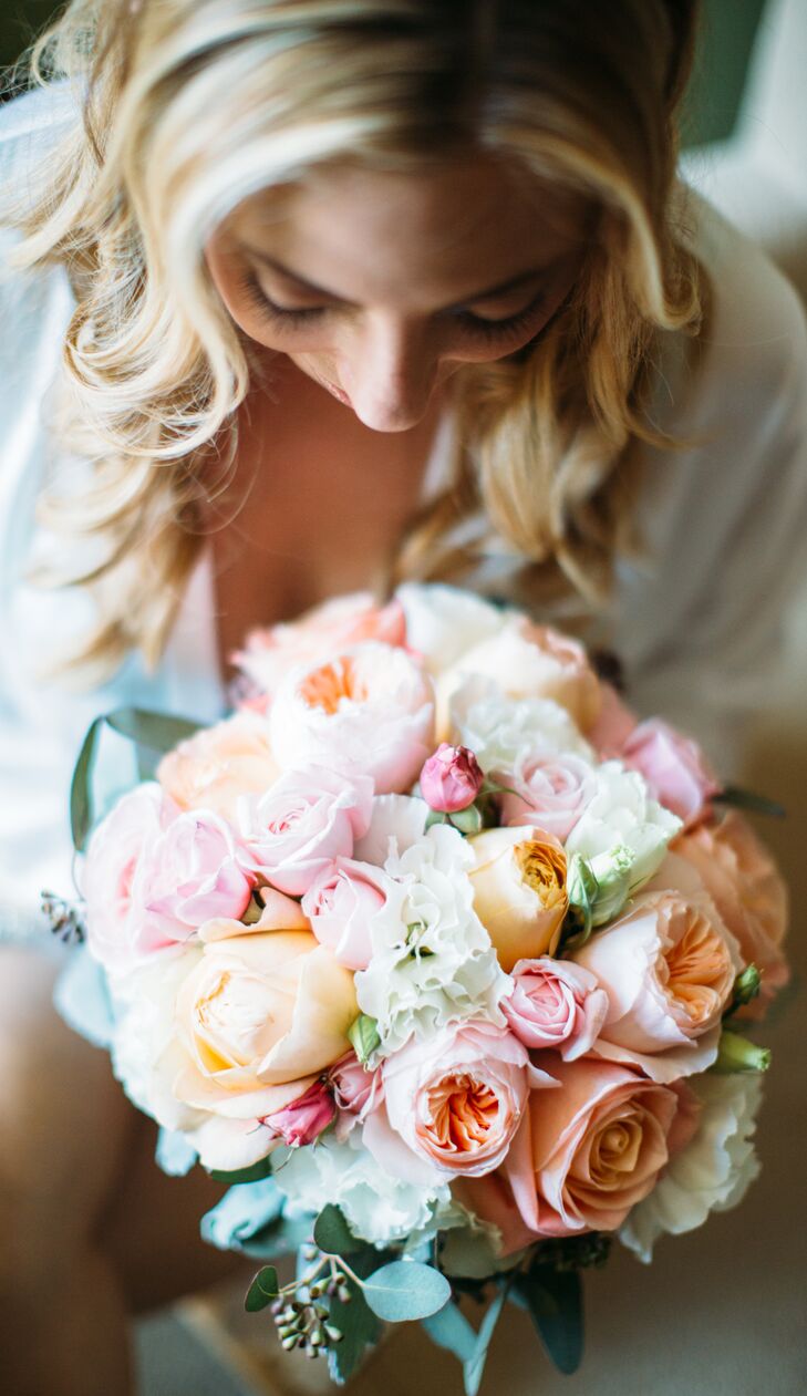 Monique held an elegant bouquet filled with pastel-colored roses and carnations, arranged by Tangled Lotus. The flowers made an appearance in many of the other arrangements that decorated the outdoor space, adding a soft touch to the shabby-chic style.