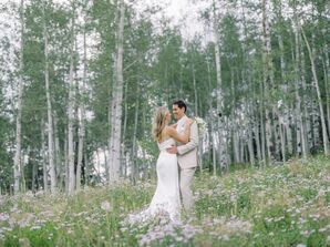 Bride and Groom in Light Color Attire Embrace in a Wildflower Field on Mountain