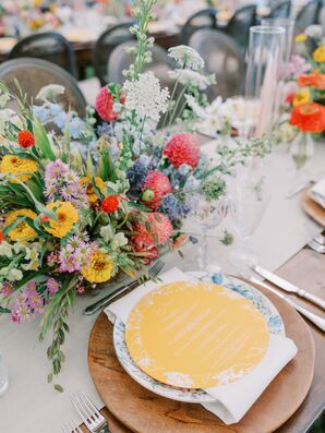 Place Setting With Wood Charger, Blue China, Yellow Menu and Wildflowers