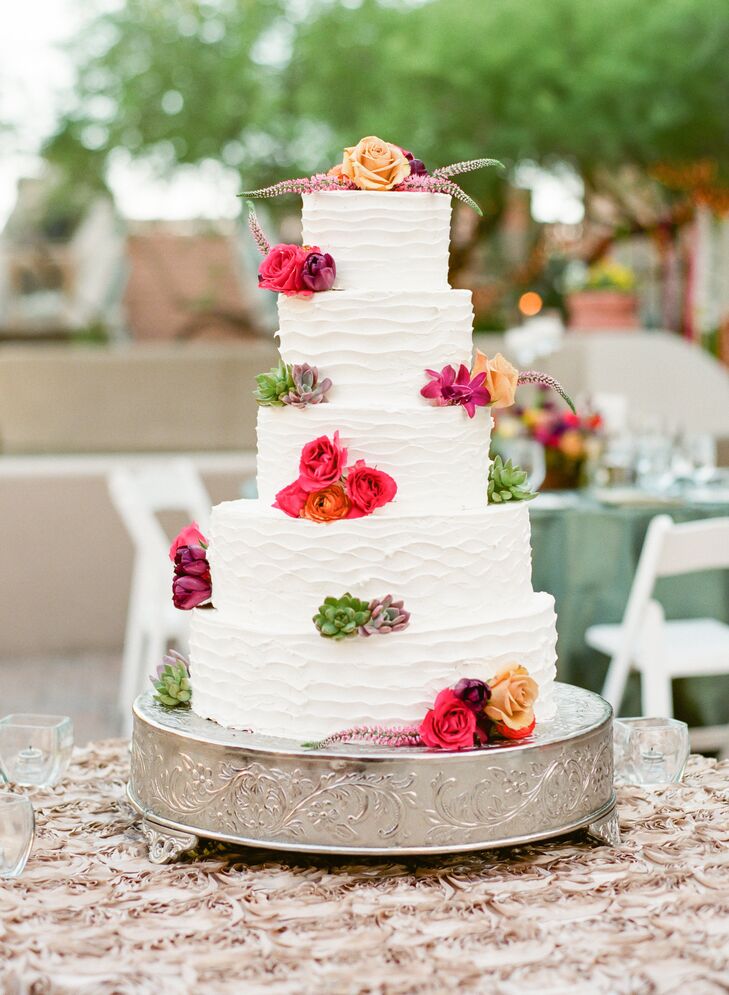 A simple, white tiered cake was transformed to with bold florals.