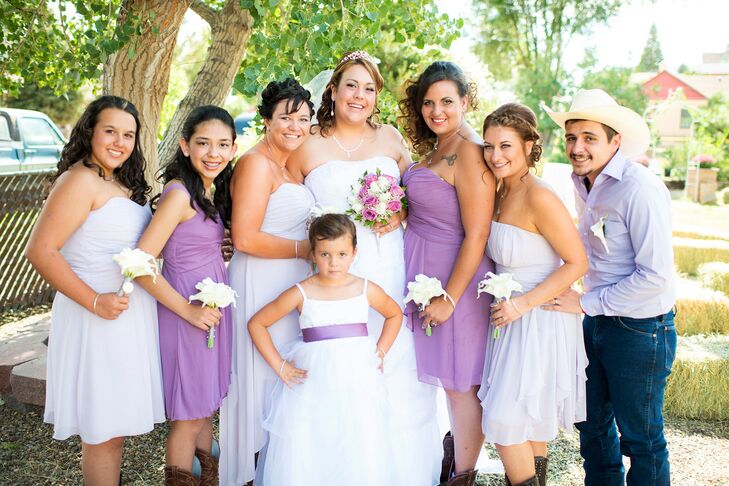 Sara's bridesmaids wore purple strapless dresses and her groomsman wore a purple shirt and jeans.