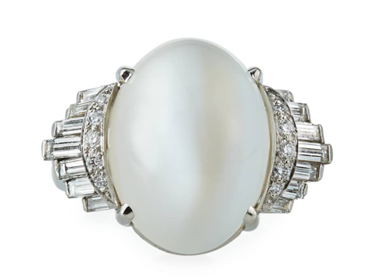 Oval moonstone center with baguette and round cut diamond accents on sides