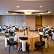 The couple kept their intimate reception simple with small white and orange centerpieces and white linens.