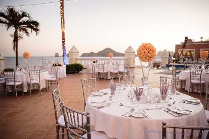 Maria and Maxwell kept their decor simple, which allowed the natural scenery to stand out. Light orange pomanders decorated the simple white dining tables for a touch of color.