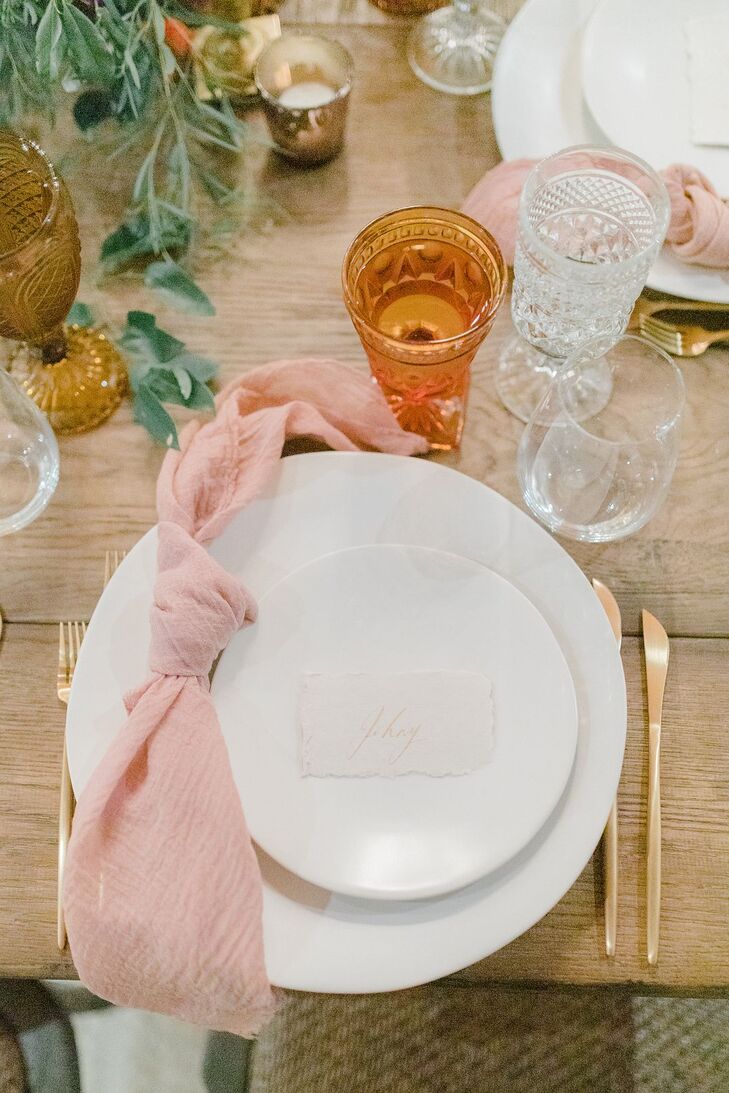 Place Setting with Blush Napkin and Gold Flatware