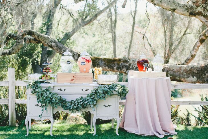 Before kicking off the ceremony, Cara and Scott invited guests to mix, mingle and sip on refreshing beverages like fresh-squeezed lemonade, iced tea and infused waters. Vintage furnishings were incorporated throughout the ceremony site. “We also used a handful of my grandparents' vintage trays and brass decor, which meant a lot since neither of my grandparents or my husband's are still with us,” Cara says.