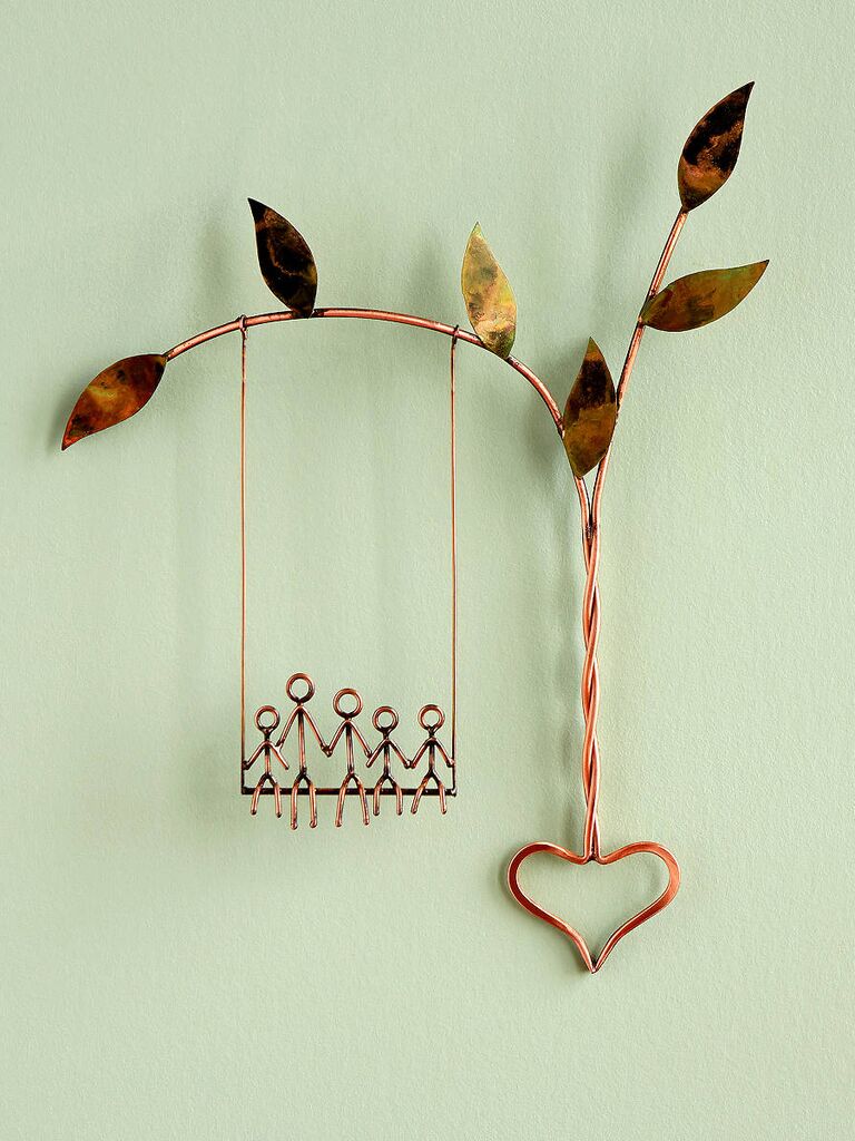 Copper wire sculpture of family on a swing