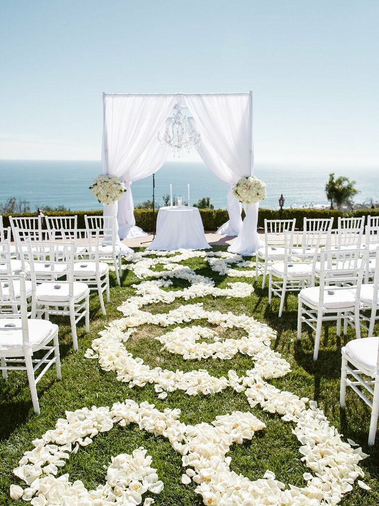 White rose aisle runner at fairytale-themed wedding