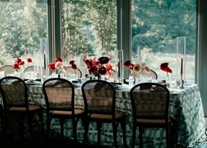 Wedding Reception Table With Wicker Chairs and Patterned Linens