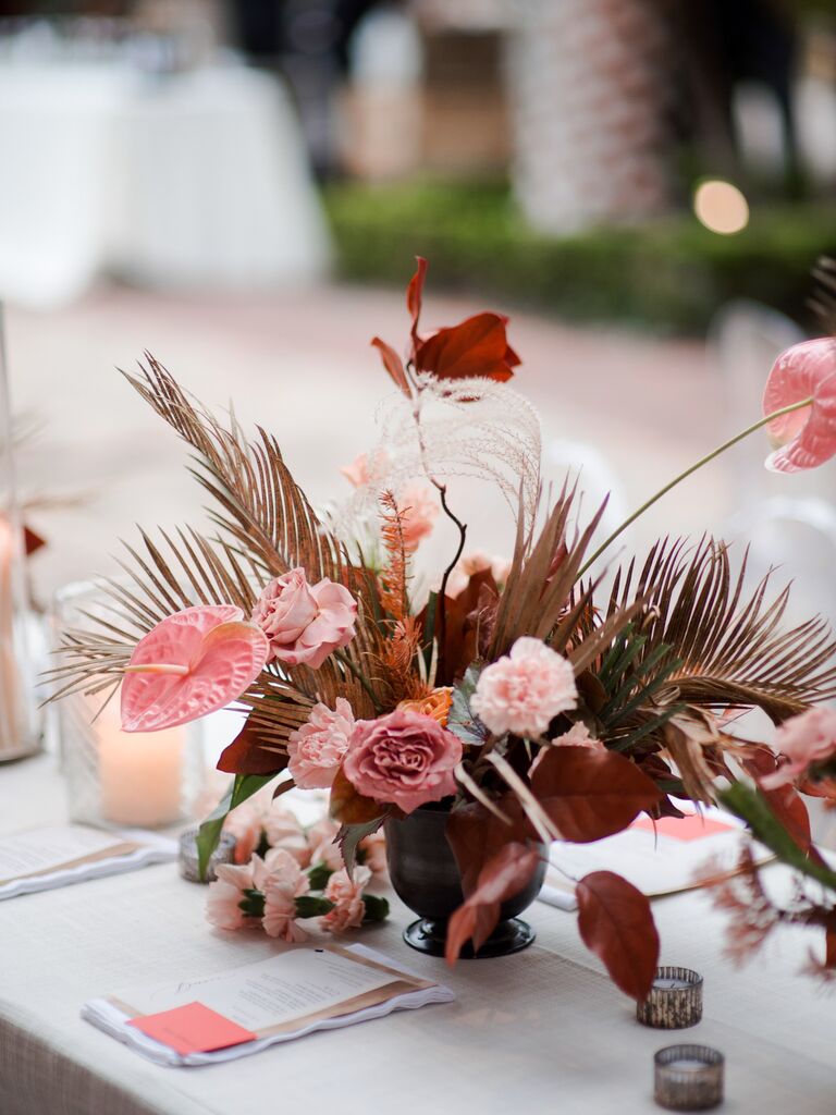 modern fall wedding centerpiece with pink anthurium, roses, carnations and pampas grass