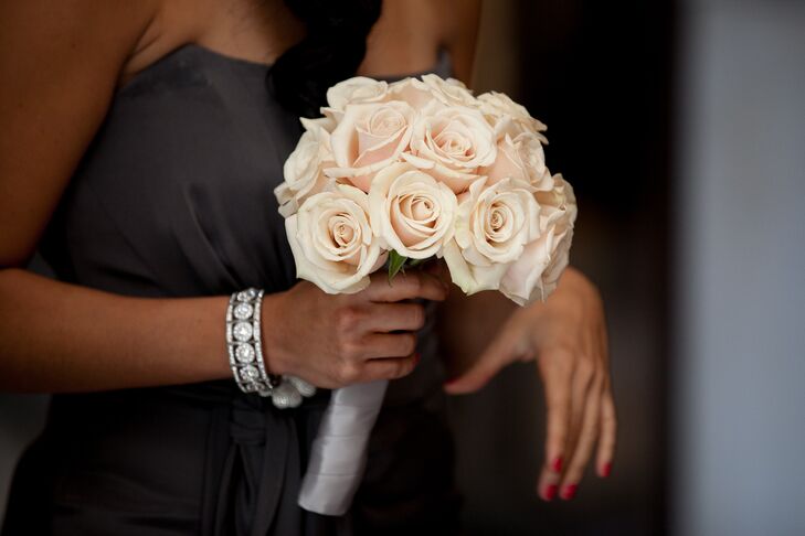 The bridesmaids carried simple, classic bouquets of blush roses, which popped against their charcoal gowns.