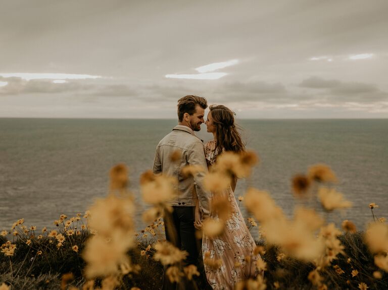 Couple hugging each other in front of ocean view in San Diego