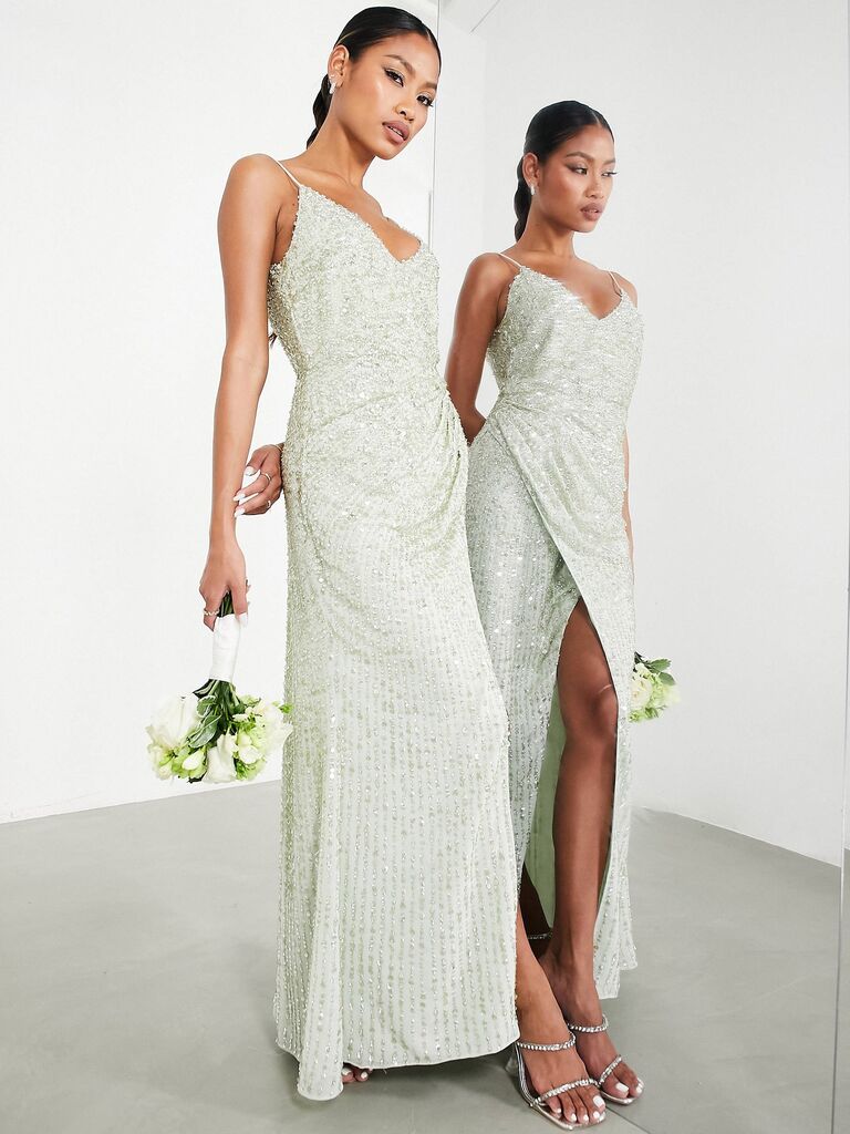 Model wears a sage-green dress with sparkly embellishments. 