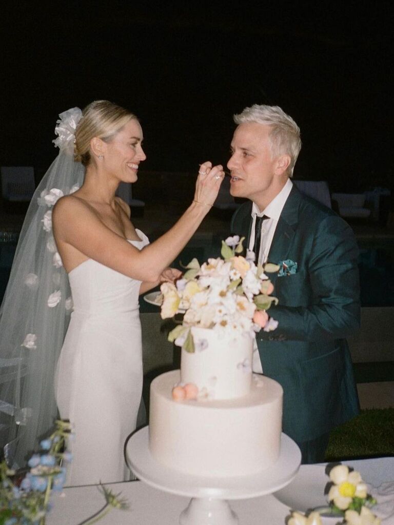 Arielle Vandenburg and Matt Cushall trying their wedding cake