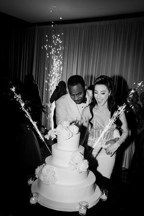 Couple Cutting Wedding Cake With Sparklers