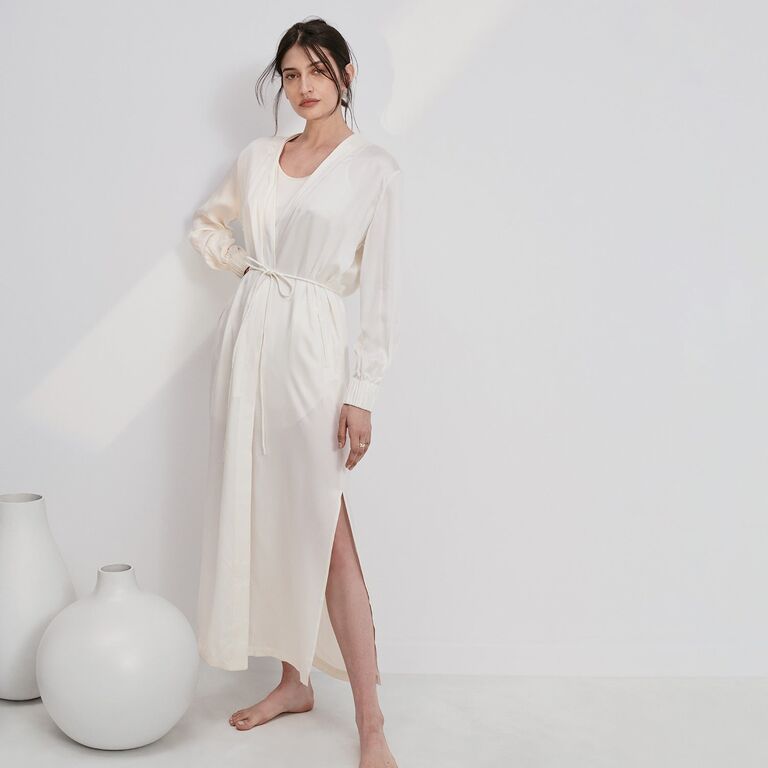 Model wears a stylish white silk robe. 