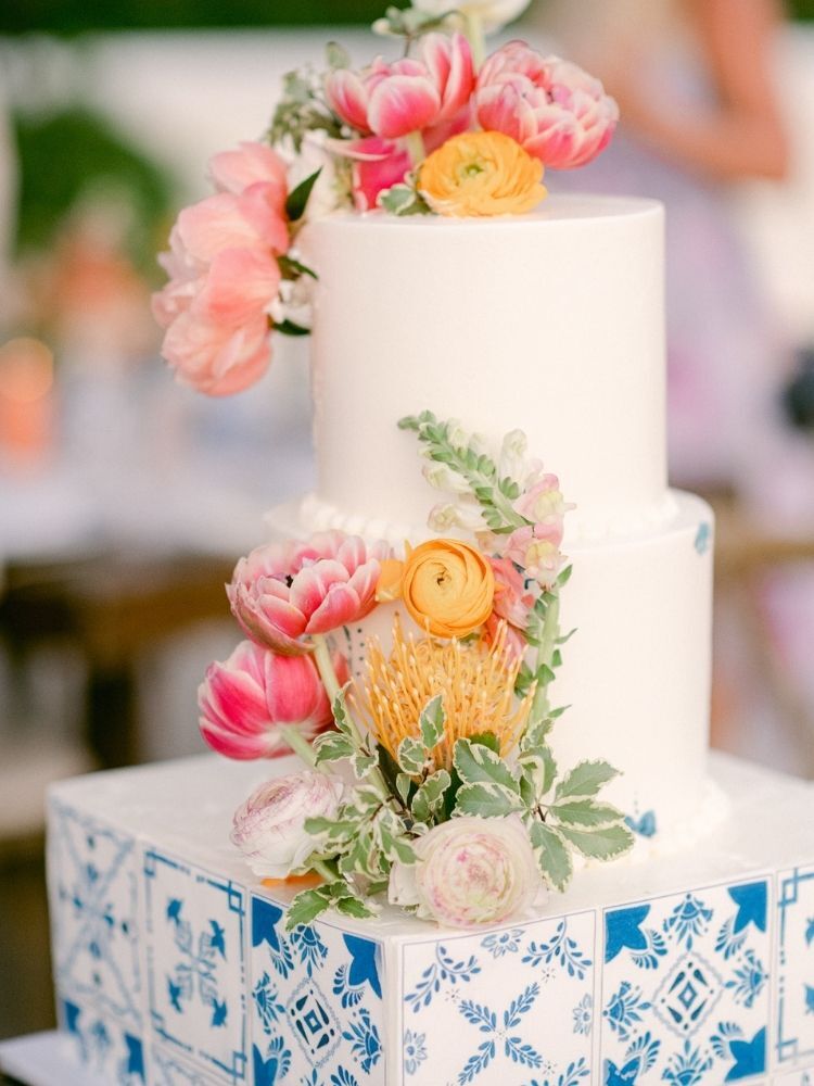 blue-and-white wedding cake with pink flowers