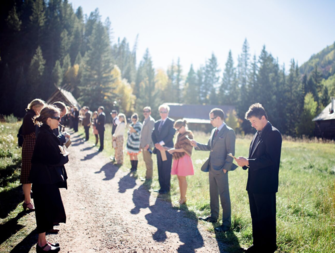 Family standing in receiving line outside before wedding ceremony 